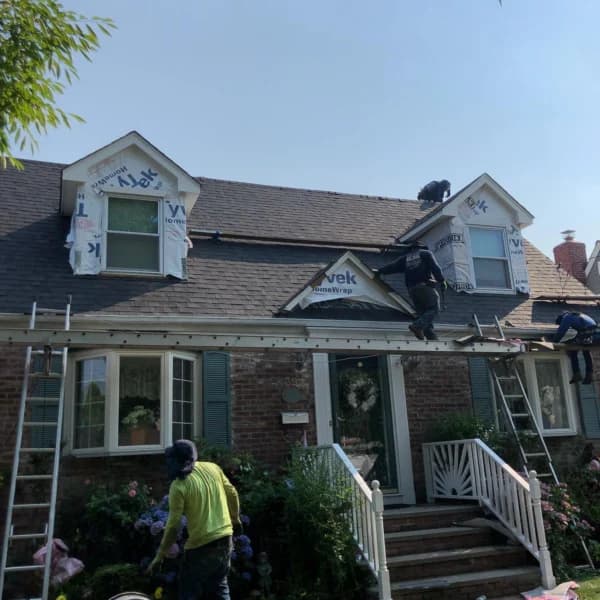 New dark shingle roof installation
