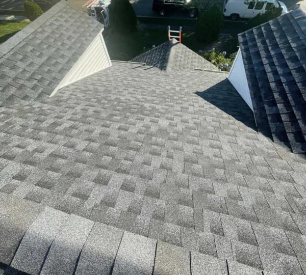 New grey shingle roof installation